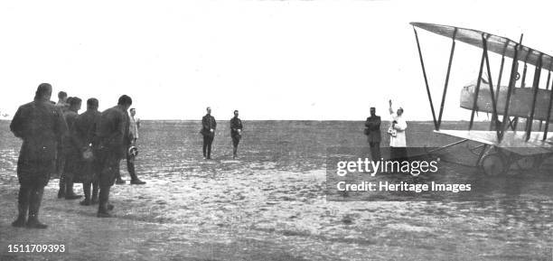 ''Le bapteme de l' "Oiseau"; Avant son premier vol au-dessus des lignes ennemies, un avion neuf est beni par un aumonier militaire', 1915. From...