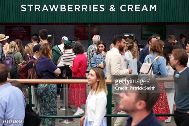 Spectators queue for a Strawberries and Cream vendor during day one of The Championships Wimbledon 2023 at All England Lawn Tennis and Croquet Club...