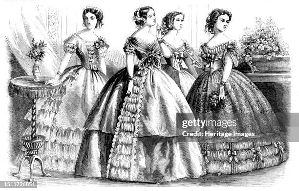 Fashions for April, 1857. Ball dresses. 'The first figure, that at the extreme left, is represented in a tunic of pink silk over a dress of white...