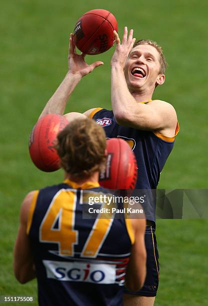 Adam Selwood warms up with Lewis Stevenson during a West Coast Eagles AFL training session at Patersons Stadium on September 3, 2012 in Perth,...