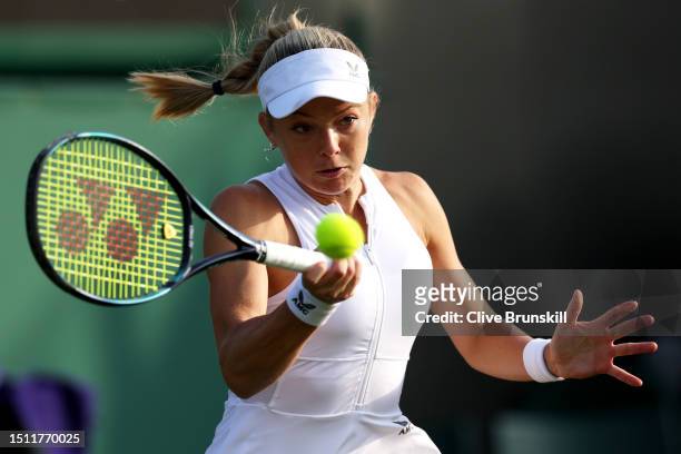 Katie Swan of Great Britain plays a forehand against Belinda Bencic of Switzerland in the Women's Singles first round match on day one of The...