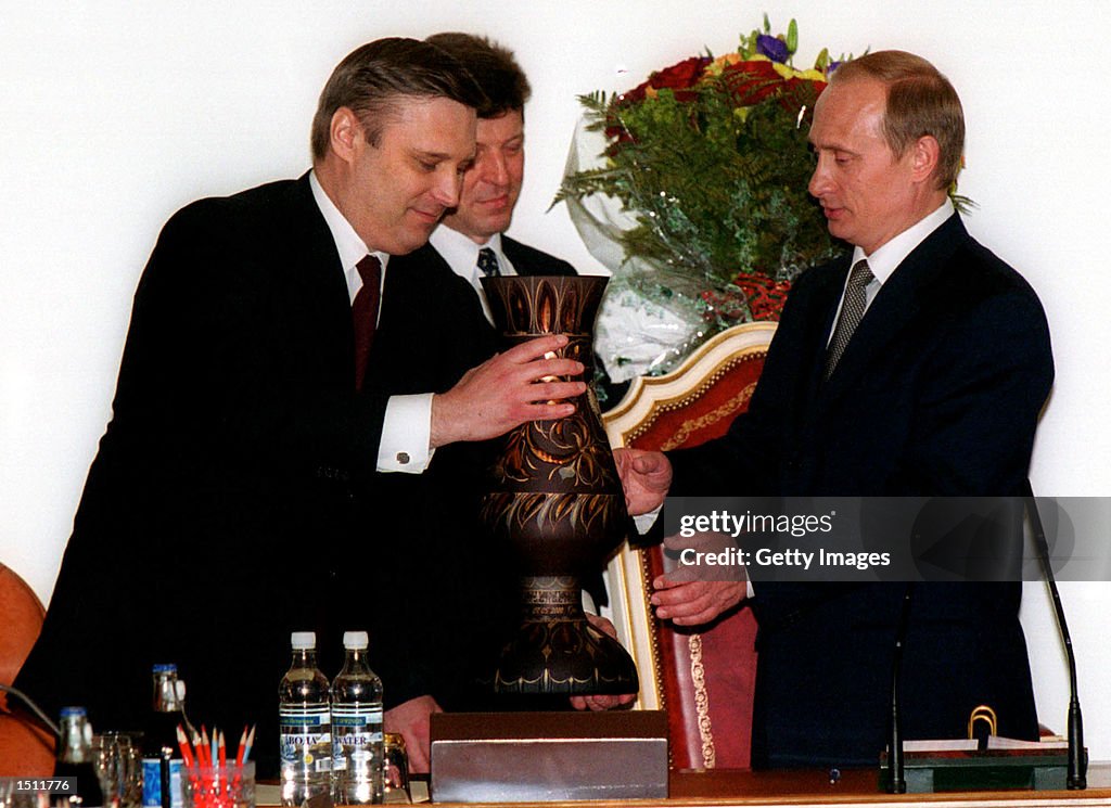 Mikhail Kosyanov presents a vase to Russian President Vladimir Putin