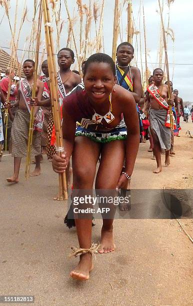 Swazi girl carries reeds on September 2, 2012 as she arrives to dance for King Mswati III at the Ludzidzini royal palace in Mbabane. Over 60,000...