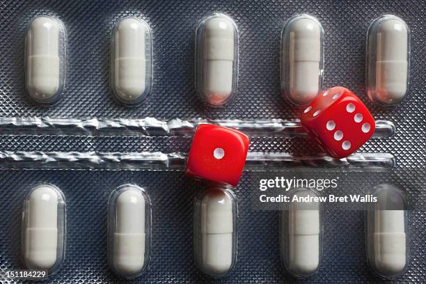 minature dice alongside prescription pills - game of chance stock pictures, royalty-free photos & images