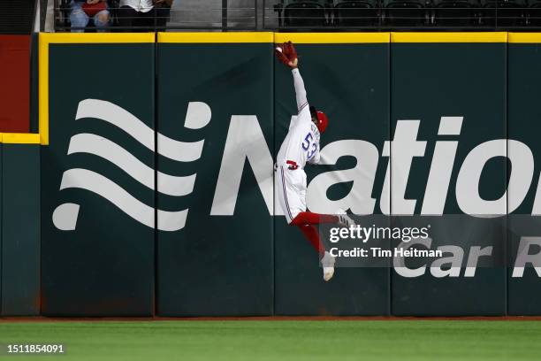 Adolis Garcia of the Texas Rangers jumps to catch a fly ball in the first inning against the Houston Astros at Globe Life Field on July 03, 2023 in...