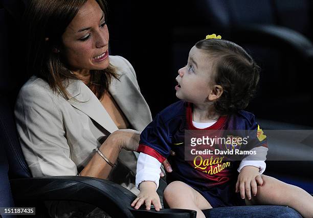 Andres Iniesta's wife Anna Ortiz and his daughter Valeria are seen prior to the La Liga match between FC Barcelona and Valencia CF at Camp Nou on...