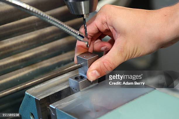 Trainee uses a milling machine at a Siemens training center on September 3, 2012 in Berlin, Germany. Nearly 400 trainees began their apprenticeship...