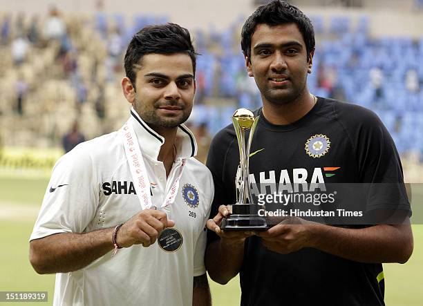 Indian Man of the match Virat Kohli and Man of the Series R Ashwin pose after victory over New Zealand during the second and last Test Cricket match...
