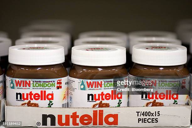 Jars of nutella hazelnut chocolate spread, manufactured by Ferrero SpA, sit in boxes on a shelf inside a supermarket in Slough, U.K., on Monday,...