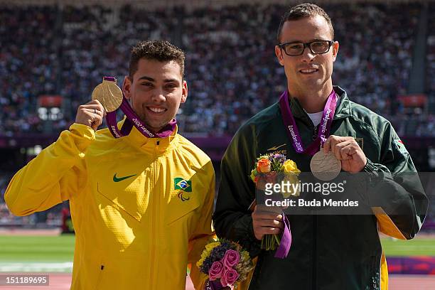 Gold medalist Alan Fonteles Cardoso Oliveira, from Brazil, and Silver medalist Oscar Pistorius, from South Africa, at the Olympic Stadium on...