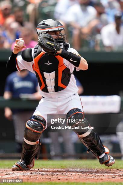 Anthony Bemboom of the Baltimore Orioles looks to throw to second base during a baseball game against the Seattle Mariners at Oriole Park at Camden...