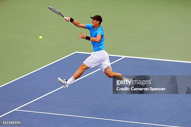 Tomas Berdych of Czech Republic returns a shot during his men's singles fourth round match against Nicolas Almagro of Spain on Day Eight of the 2012...
