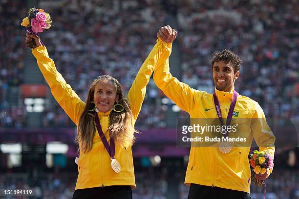 Alan Fonteles Cardoso Oliveira of Brazil celebrates a gold medal in the Men's 200m - T44 with Terezinha Guilhermina, also from Brazil, who won gold...