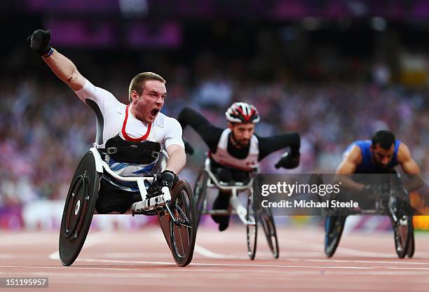 Mickey Bushell of Great Britain crosses the line to win gold in the Men's 100m - T53 Final on day 5 of the London 2012 Paralympic Games at Olympic...