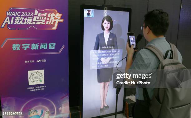 Viewer takes a photo of a digital news officer produced by Sensetime at WAIC 2023 in Shanghai, China, July 6, 2023.