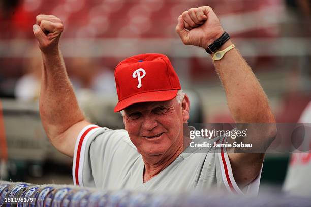 Manager Charlie Manuel of the Philadelphia Phillies signals one of his players before the start of a game against the Cincinnati Reds at Great...