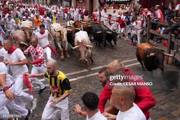 Participants run ahead of bulls during the "encierro" of the San Fermin festival in Pamplona, northern Spain, on July 7, 2023. Thousands of people...