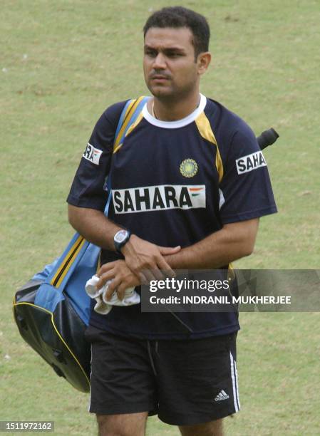 Indian cricketer Virender Sehwag nurses a sore wrist as he walks back from the nets on the concluding day of a six day-long cricketers conditioning...