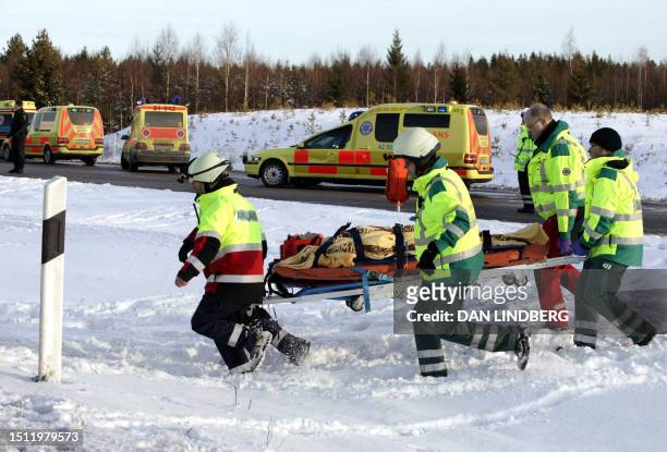 Rescue personnel work at the site of a bus accident at a highway near Arboga some 100 kilometers west of Stockholm 27 January 2006. At least seven...