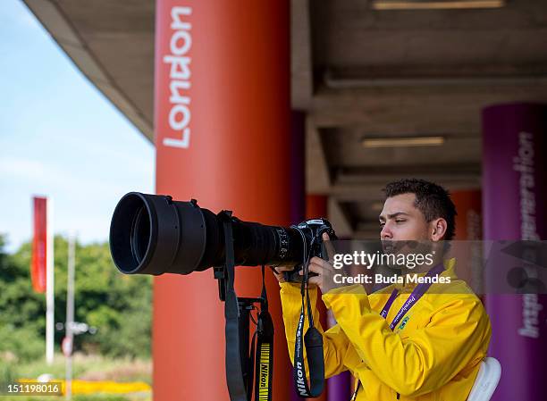 Alan Fonteles Cardoso Oliveira from Brazil tests the photographer's equipment after receiving the gold medal at the London 2012 Paralympic Games at...