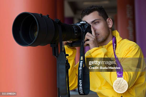 Alan Fonteles Cardoso Oliveira from Brazil tests the photographer's equipment after receiving the gold medal at the London 2012 Paralympic Games at...