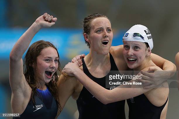 Maddison Elliot, Ellie Cole and Katherine Downie of Australia celebrate as teammate Jacqueline Freney wins them the gold medal in the Women's 4x100m...