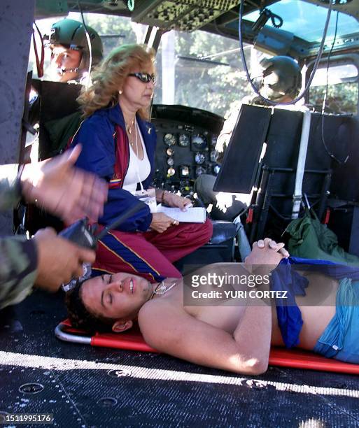 The member of the paddle team of Venezuela, Miguel Vargas, which disappeared today in the morning, is taken 20 November 2002 in a helicopter to the...
