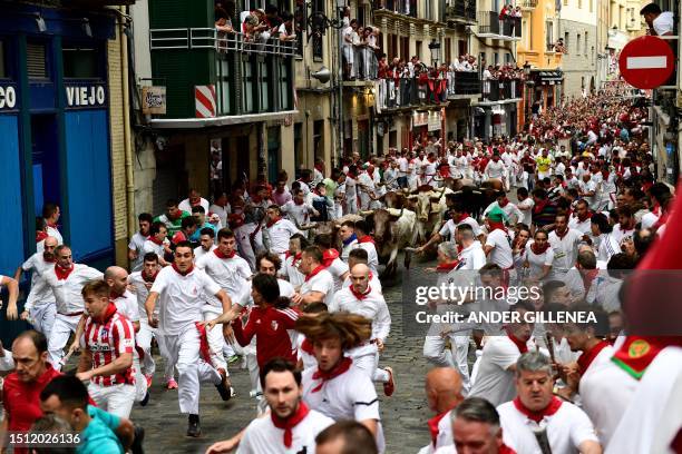 Participants run ahead of bulls during the first "encierro" of the San Fermin festival in Pamplona, northern Spain, on July 7, 2023. Thousands of...