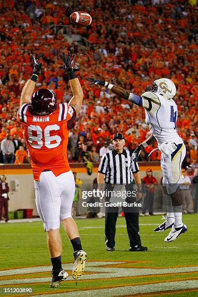 Tight end Eric Martin of the Virginia Tech Hokies catches the ball for a touchdown over defensive back Jamal Golden of the Georgia Tech Yellow...