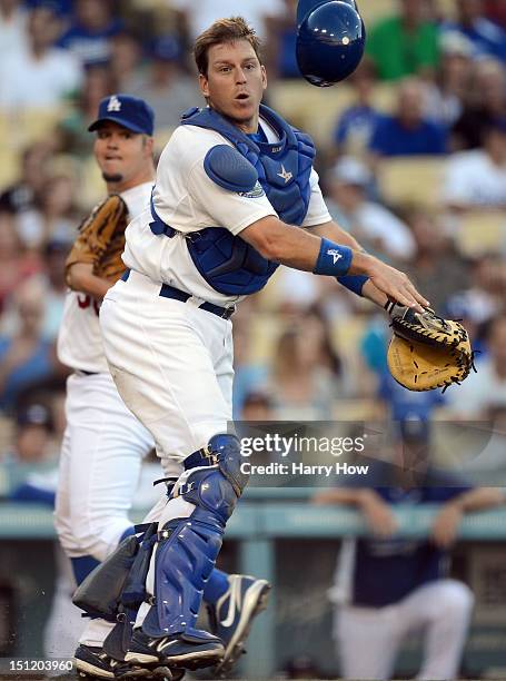 Ellis of the Los Angeles Dodgers makes a throw to first in front of Joe Blanton for an out of Everth Cabrera of the San Diego Padres during the third...