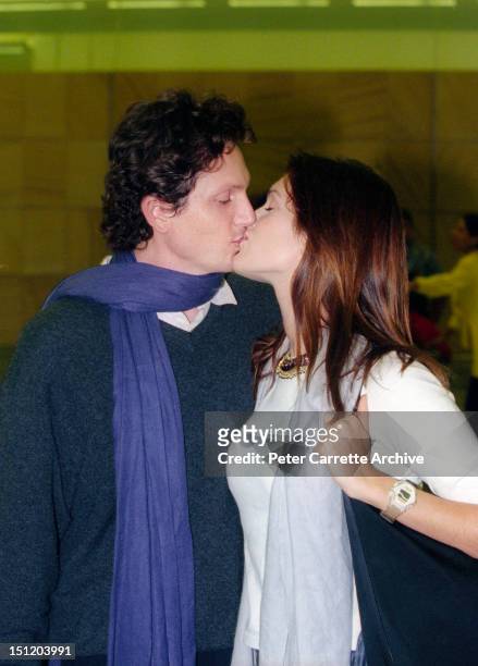 Australian model and actress Kate Fischer and boyfriend Gregory Alosio arrive at Sydney International Airport on January 13, 2000 in Sydney,...