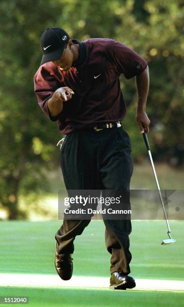 Tiger Woods reacts after making a putt on the first hole of the playoff August 20, 2000 during the PGA Championship at the Valhalla Golf Club in...
