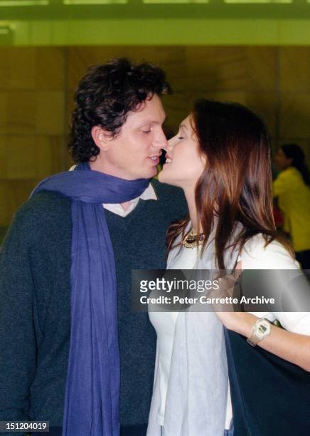 Australian model and actress Kate Fischer and boyfriend Gregory Alosio arrive at Sydney International Airport on January 13, 2000 in Sydney,...