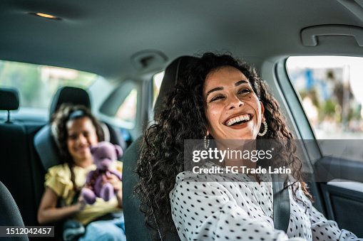 Mother and daughter talking at car