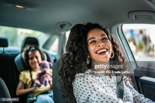 mother and daughter talking at car - family inside car bildbanksfoton och bilder