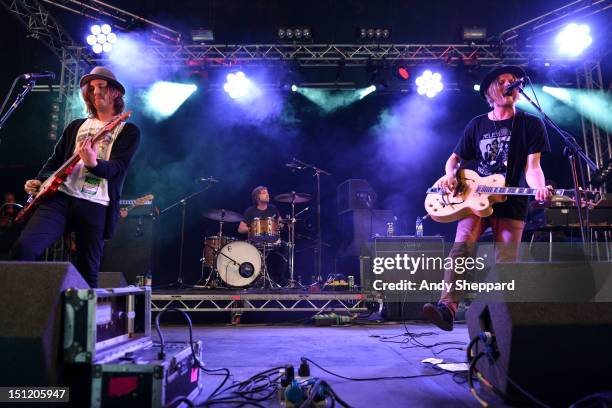 Aaron Lee Tasjan, Fredrik Aspelin and Petter Ericson Stakee of the band Alberta Cross performs on stage during Reading Festival 2012 at Richfield...