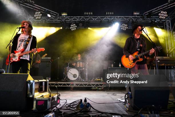 Aaron Lee Tasjan, Fredrik Aspelin and Petter Ericson Stakee of the band Alberta Cross performs on stage during Reading Festival 2012 at Richfield...