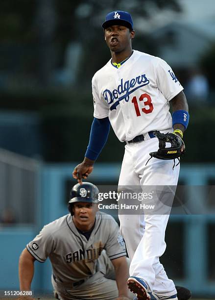 Hanley Ramirez of the Los Angeles Dodgers and Will Venable of the San Diego Padres react to a throw to first during the fifth inning at Dodger...