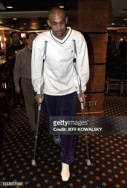 Detroit Pistons' Grant Hill exits a news conference 26 April 2000 at the Palace of Auburn Hills, Michigan, where he announced he had suffered a...