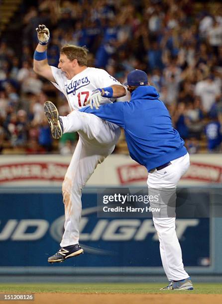 Ellis of the Los Angeles Dodgers celebrates his game winning single with Clayton Kershaw for a 4-3 win over the San Diego Padres during the 11th...