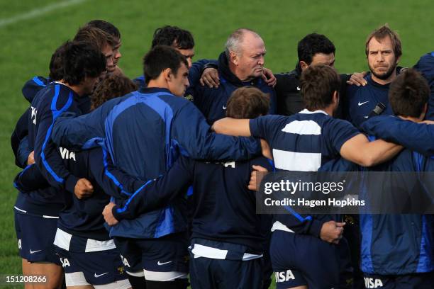 Graham Henry takes part in a team huddle during an Argentina training session at Hutt Recreation Ground on September 4, 2012 in Lower Hutt, New...