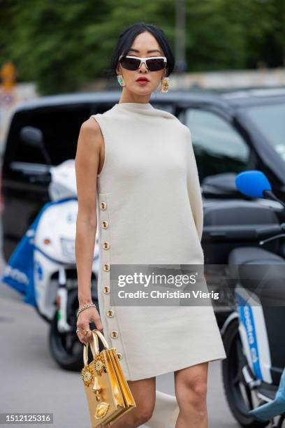 Chriselle Lim is seen wearing golden bag, beige asymmetric skit outside Schiaparelli during the Haute Couture Fall/Winter 2023/2024 as part of Paris...