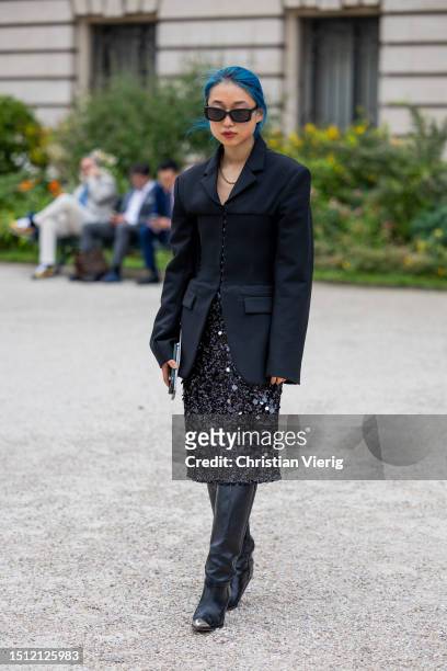 Margaret Zhang is seen wearing black blazer, sequined skirt, boots outside Schiaparelli during the Haute Couture Fall/Winter 2023/2024 as part of...