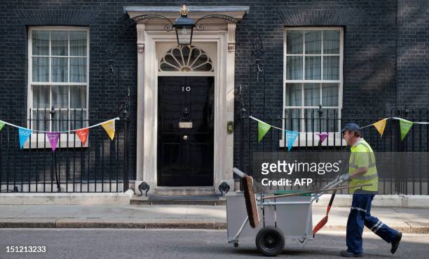 Road sweeper cleans outside no 10 Downing Street in central London on September 4, 2012 before Britain's Prime Minister David Cameron announces his...