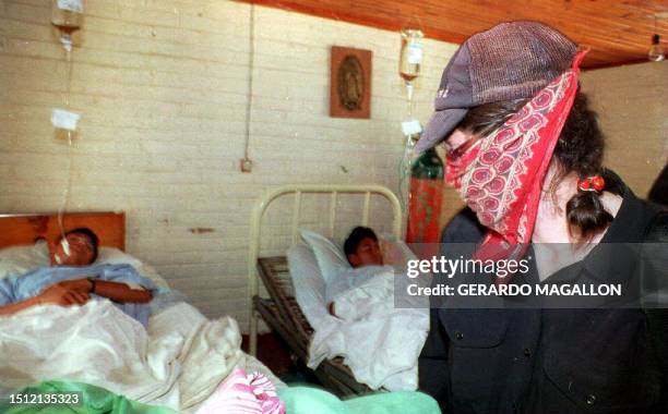 "Alejandra" , a member of the Mexican Indian peasant rebel movement Zapatista National Liberation Army checks on one of her injured comrades 03...