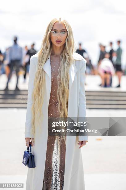 Christine Quinn is seen wearing transparent dress, white long coat, bag outside Georges Hobeika during the Haute Couture Fall/Winter 2023/2024 as...