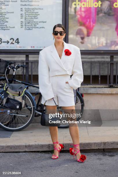 Gili Biegun is seen wearing white cropped blazer, shorts, black YSL bag, red laced sandals outside Georges Hobeika during the Haute Couture...