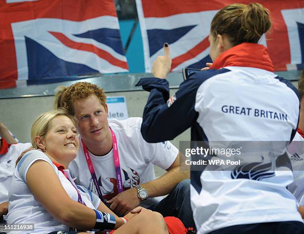 Prince Harry poses for photos with with Team GB swimmers on day 6 of the London 2012 Paralympic Games at the Aquatics Centre on September 4, 2012 in...