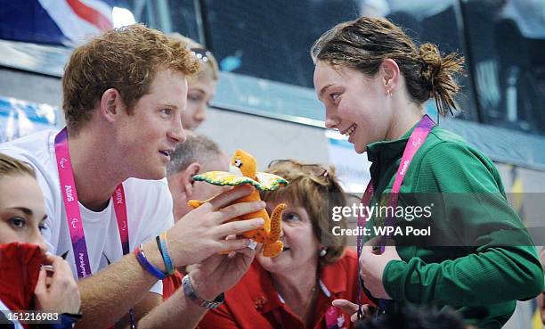 Prince Harry is given a mascot from Australian Paralympic swimmer Maddison Elliott on day 6 of the London 2012 Paralympic Games at the Aquatics...