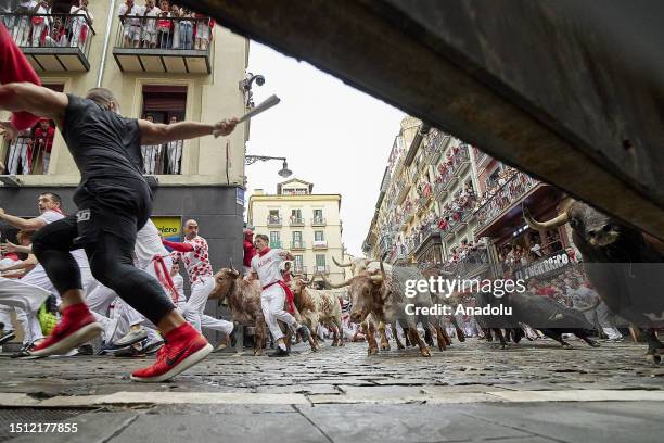 People take part in the traditional 'encierro' of the San Fermin Festival in Pamplona, Spain on July 07, 2023. The bull-running fiesta is held...